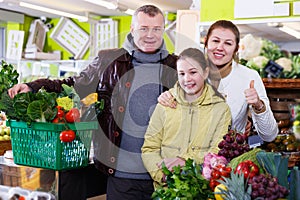 Family satisfied with shopping in greengrocery