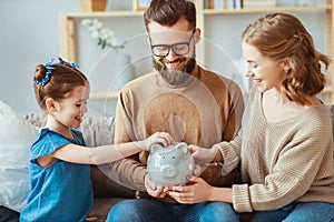 Family savings, budget planning, children`s pocket money. family with piggy Bank