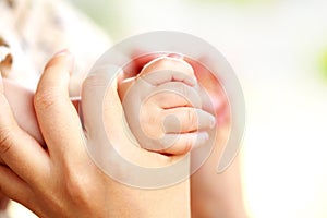 Family scene , close up parent and baby holding hands together