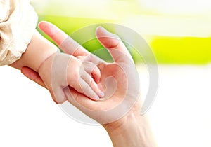 Family scene , close up parent and baby holding hands together