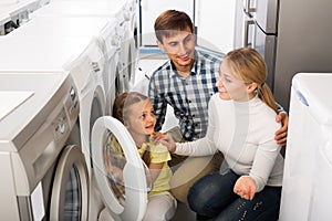 Family selecting laundry washer