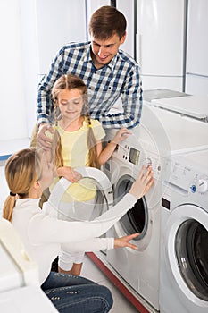 Family selecting laundry washer