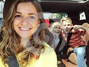 Family selfie photo in car on summer vacation