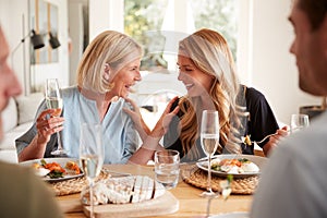 Family With Senior Parents And Adult Offspring Eating Brunch Around Table At Home Together