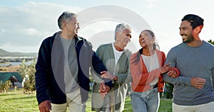 Family, senior parents and couple walking in nature for bonding, quality time and happiness. Talking, love and elderly