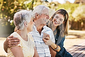 Family, senior parents and woman holding with care, love and hug bonding outdoor in a park. Smile, happy person and