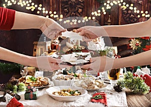 Family sharing Christmas Eve wafer at the festive table