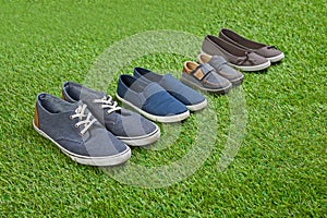 Family shoes standing on green summer grass
