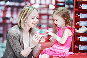 Family shopping choosing child footwear shoes