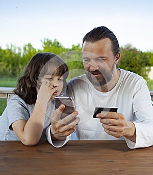 Family shopping online in the terrace on a summer evening