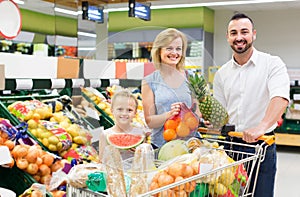 Family shopping various fresh fruits in supermarket