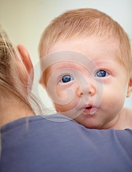 Family, shoulder and face of baby with mother in home for bonding, loving relationship and affection. Love, bedroom and
