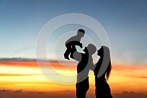 Family silhouette at sunset with son