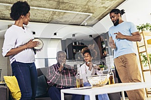 Family singing karaoke with microphones at home