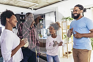 Family singing karaoke with microphones at home