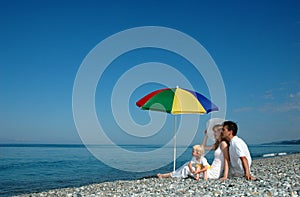 Family sit on a beach