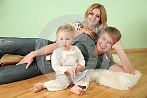 Family sit in the room on floor