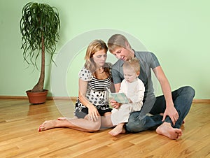 Family sit in the room on floor