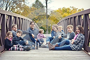 Family Sitting on a bridge