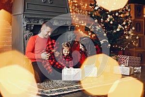 Family sitting at home near christmas tree