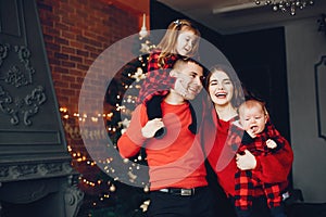 Family sitting at home near christmas tree