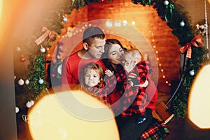 Family sitting at home near christmas tree