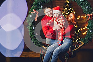 Family sitting at home near christmas tree