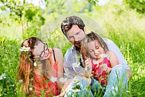 Family sitting on meadow