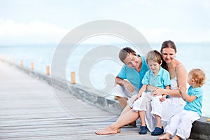 Family sitting outdoors at seashore