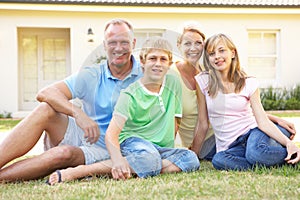 Family Sitting Outside Dream Home