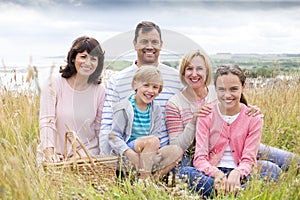 Family sitting on the sand dunes