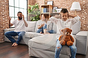 Family sitting on sofa and kid sad for partents argue at home