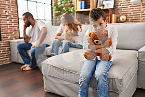 Family sitting on sofa and kid sad for partents argue at home