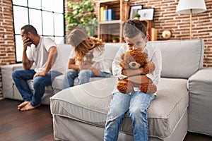 Family sitting on sofa and kid sad for partents argue at home