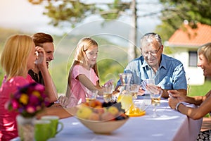 Family sitting at table playing cards