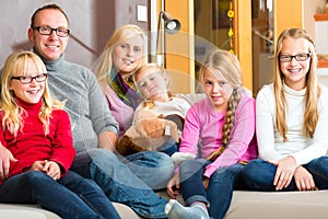 Family sitting together on sofa