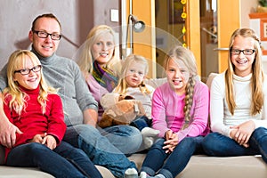 Family sitting together on sofa