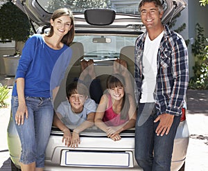 Family Sitting In Trunk Of Car