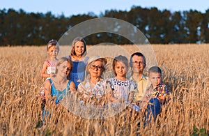 Family sitting in wheat field