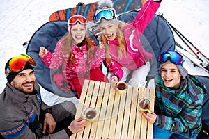 Family ski and snow fun in winter mountains