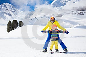 Family skiing in mountains. Mother and kid ski