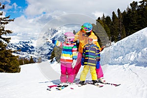 Family skiing in mountains. Mother and kid ski