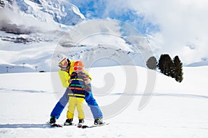 Family skiing in mountains. Mother and kid ski