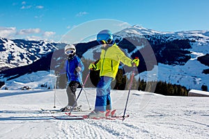 Family, skiing in winter ski resort on a sunny day, enjoying landscape
