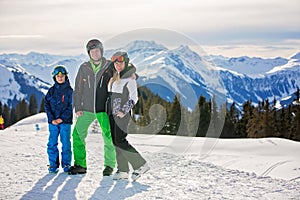 Family, skiing in winter ski resort on a sunny day, enjoying landscape