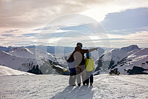 Family, skiing in winter ski resort on a sunny day, enjoying nature