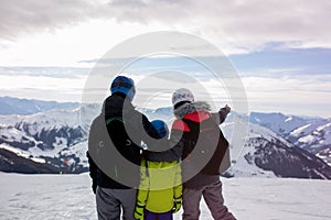 Family, skiing in winter ski resort on a sunny day, enjoying nature