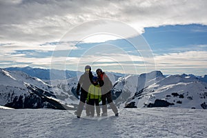 Family, skiing in winter ski resort on a sunny day, enjoying nature