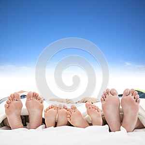 Family sleeping on the bed