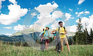 Family with small children cycling outdoors in summer nature, Tatra mountains Slovakia.